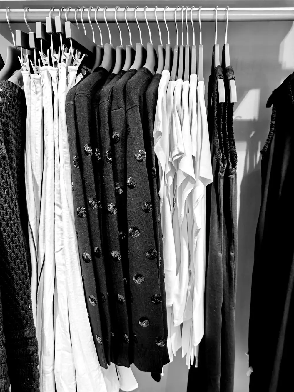 Reference photo 4: black and white clothing on hangers in a closet — abayas & kaftans we manufacture and export in bulk to United Arab Emirates