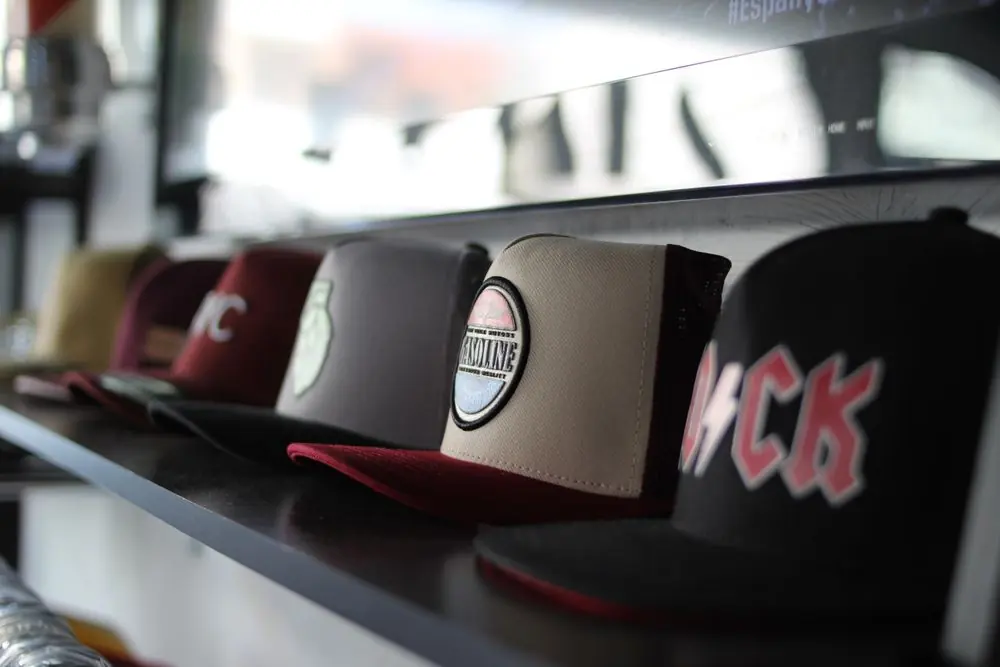 Reference photo 2: baseball caps on a shop shelf — caps we manufacture and export in bulk to Kenya