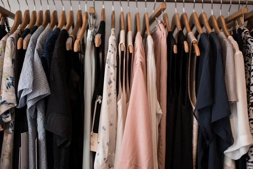 Reference photo 2: women's dresses and tops on wooden hangers in a boutique — ladies tops & dresses we manufacture and export in bulk to Canada