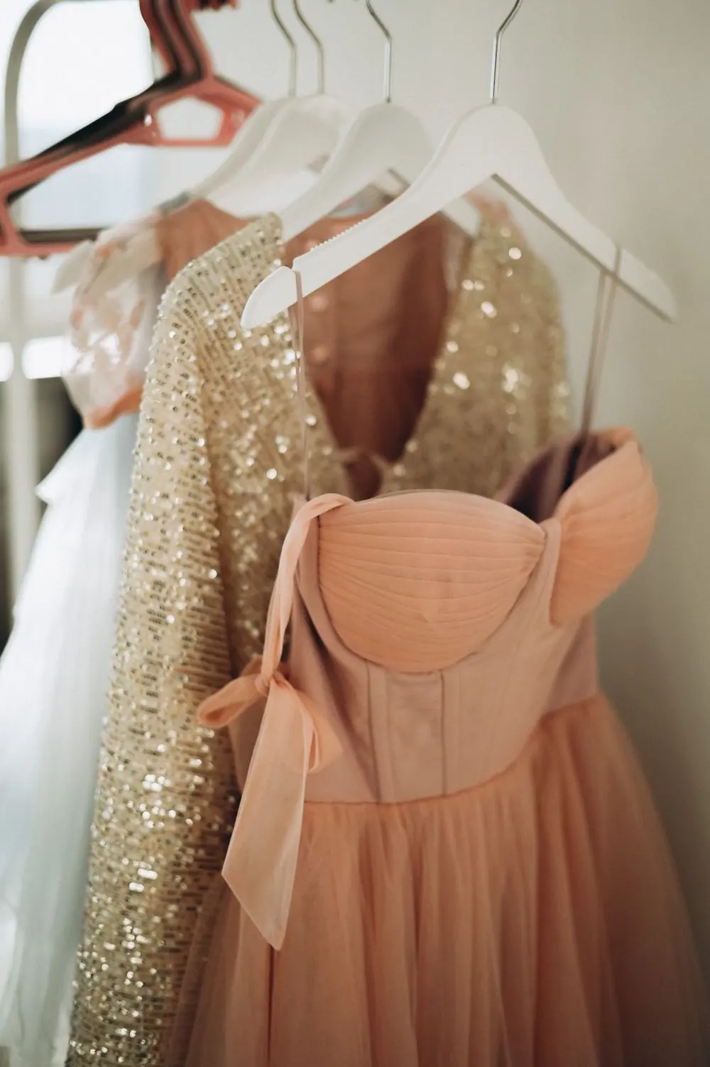 Reference photo 3: peach and sequin dresses on hangers — ladies tops & dresses we manufacture and export in bulk to Canada