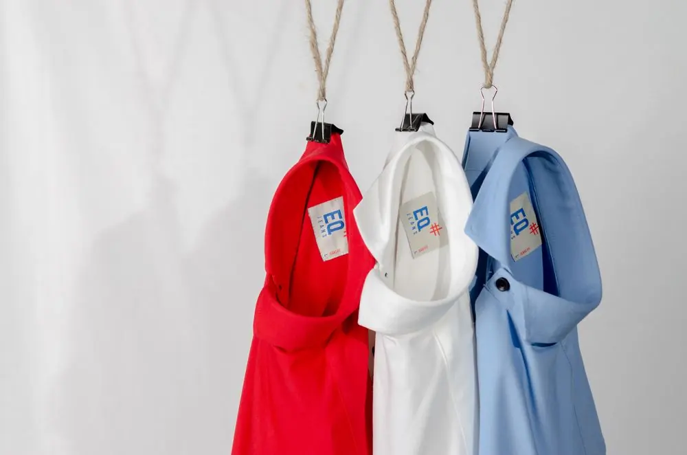 Reference photo 4: red, white and blue polo shirts on hangers — polo t-shirts we manufacture and export in bulk to Qatar
