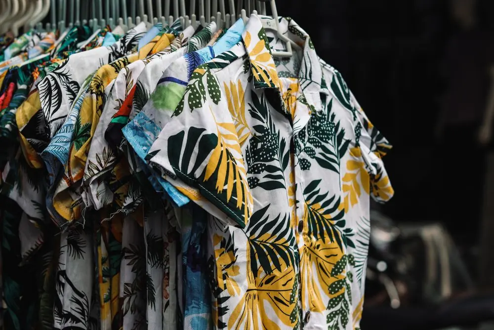 Reference photo 2: tropical print shirts on a display rack — printed shirts we manufacture and export in bulk to Oman