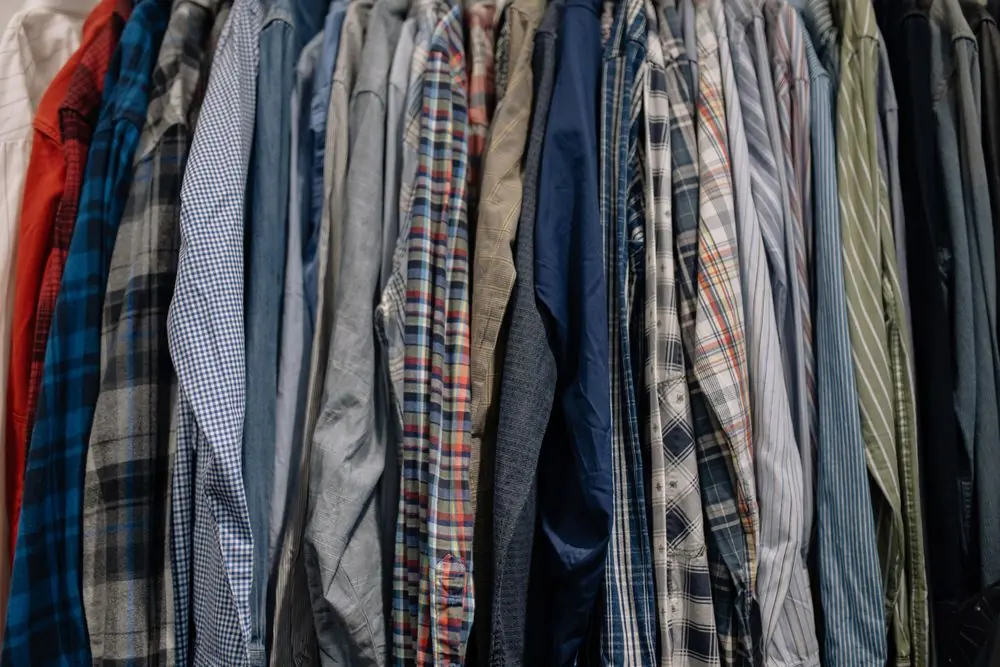 Reference photo 3: check and plaid shirts on a clothes rack — printed shirts we manufacture and export in bulk to Oman