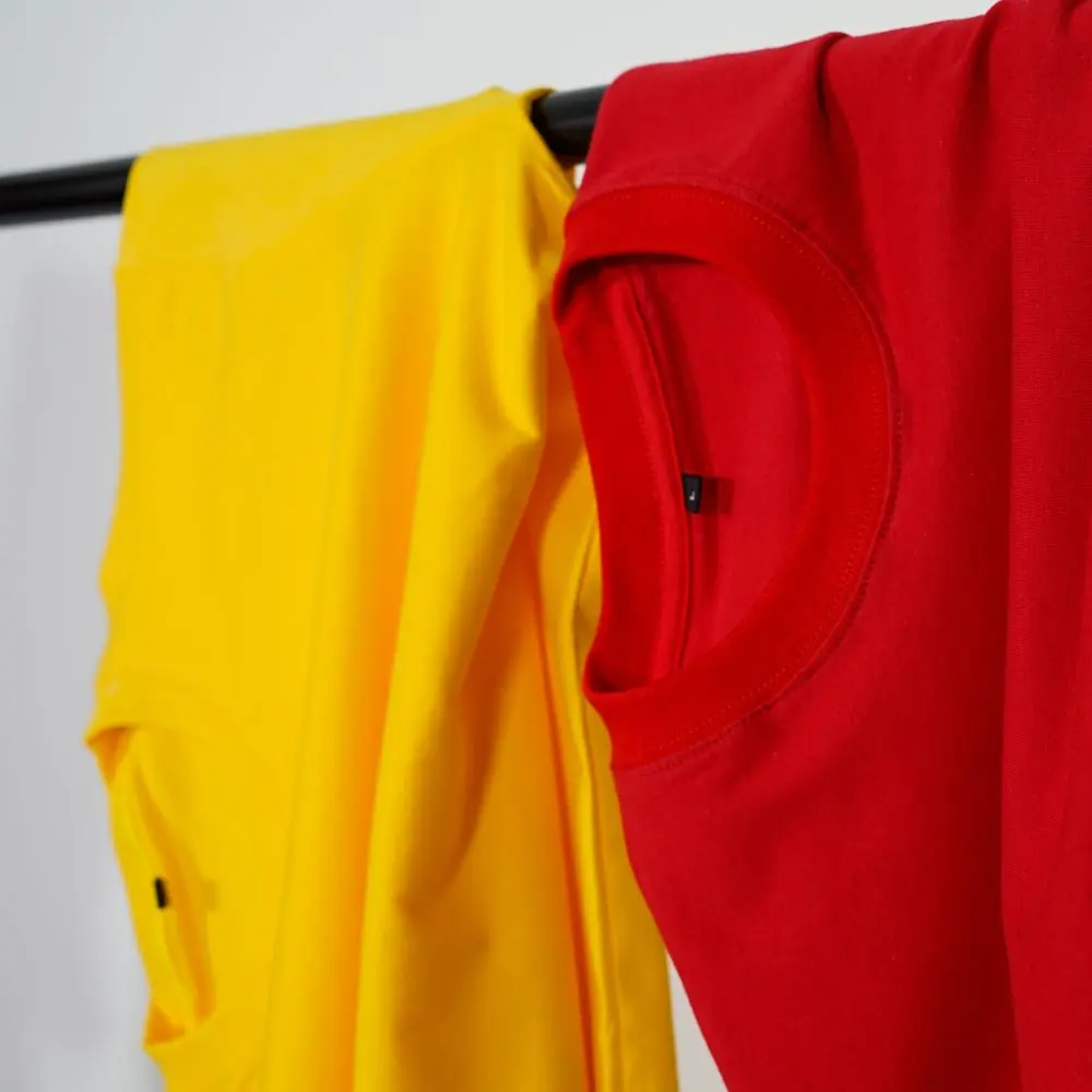 Reference photo 2: yellow and red sports-style T-shirts on a rail — sportswear & jerseys we manufacture and export in bulk to South Africa