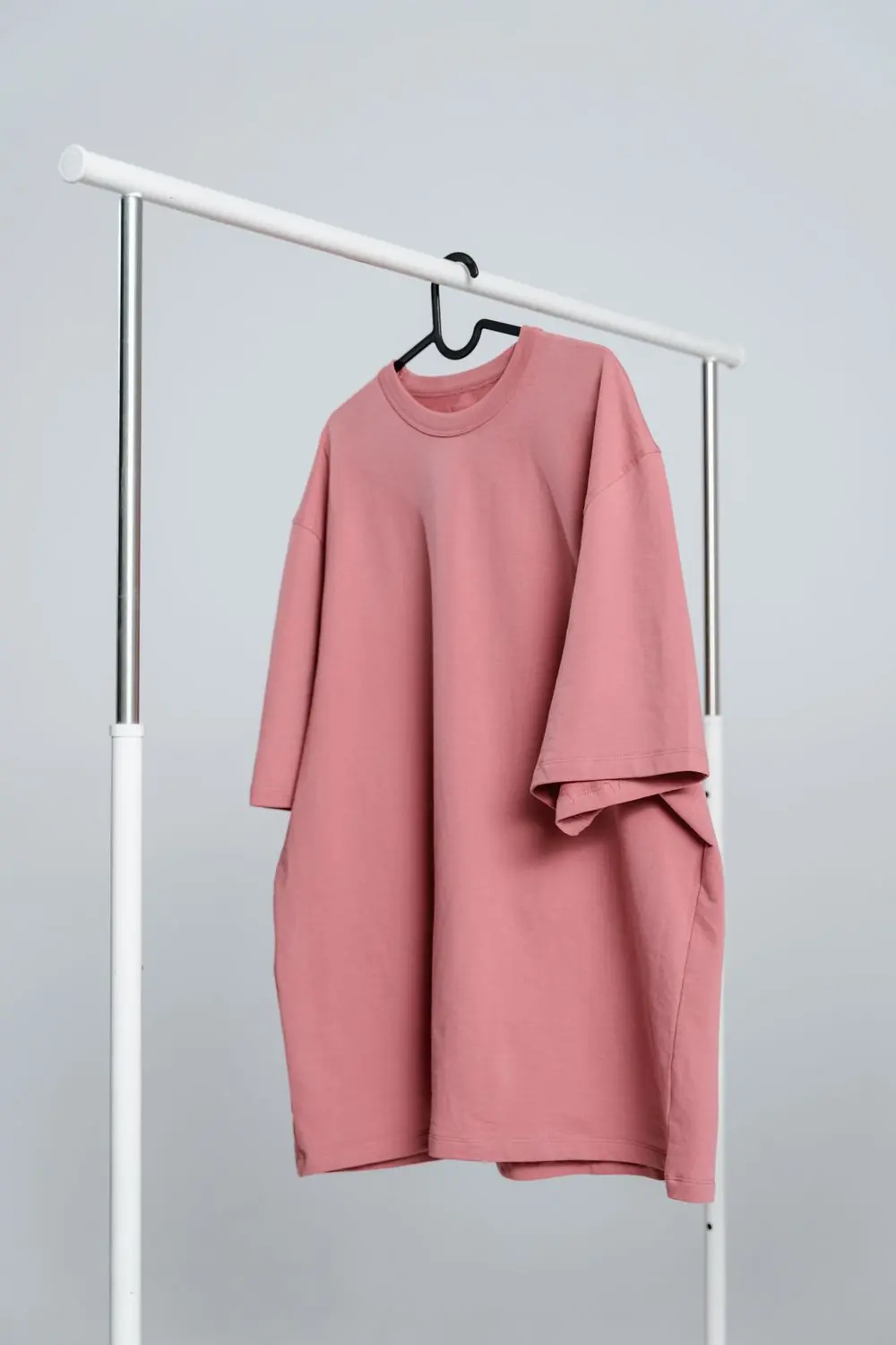 Reference photo 5: pink oversized T-shirt on a rail — t-shirts we manufacture and export in bulk