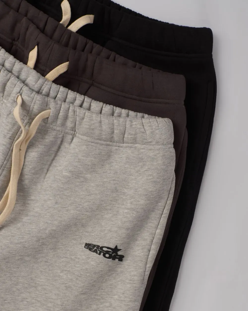 Reference photo 3: folded sweatpants laid flat — track pants & shorts we manufacture and export in bulk to Kenya