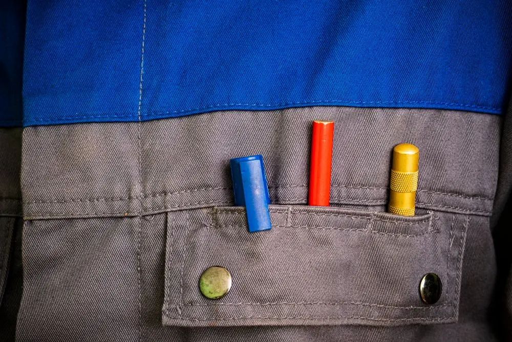 Reference photo 2: workwear jacket pocket with tools — workwear & corporate uniforms we manufacture and export in bulk to Qatar