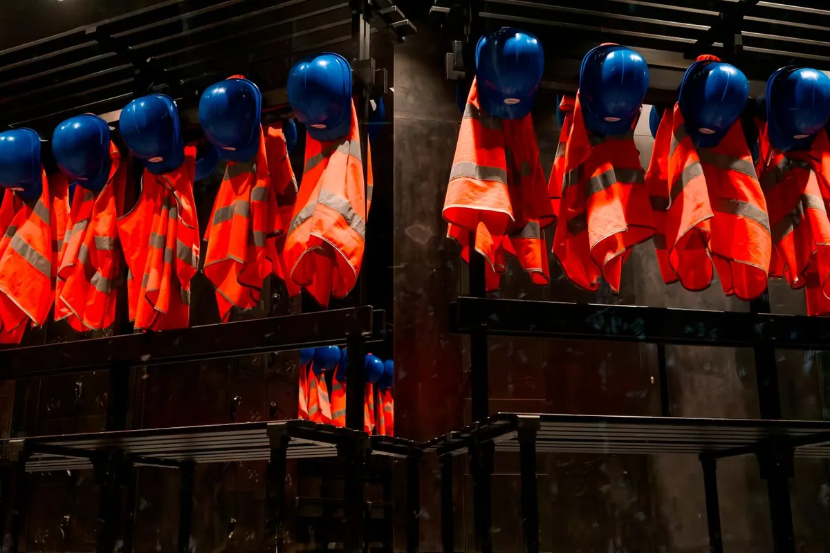 Workwear & Corporate Uniforms: row of hi-vis safety vests and helmets — reference photo from our export range